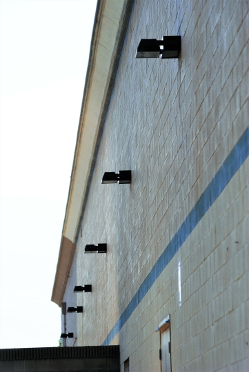 Wall pack fixtures along the side of a commercial building