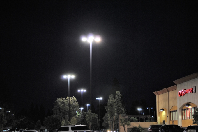 Parking lot pole lights lit at night