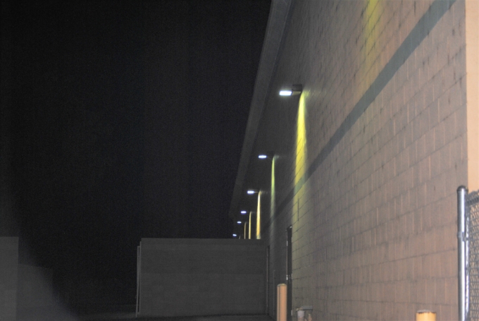 Wall-mounted lights washing a building at night